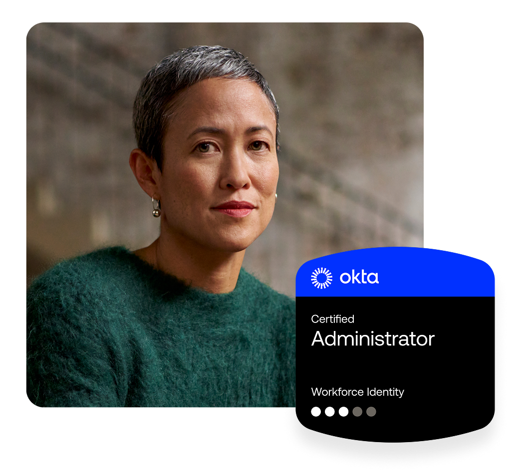 Woman with short grey hair and a dark green sweater, next to an Okta Certified Administrator badge.