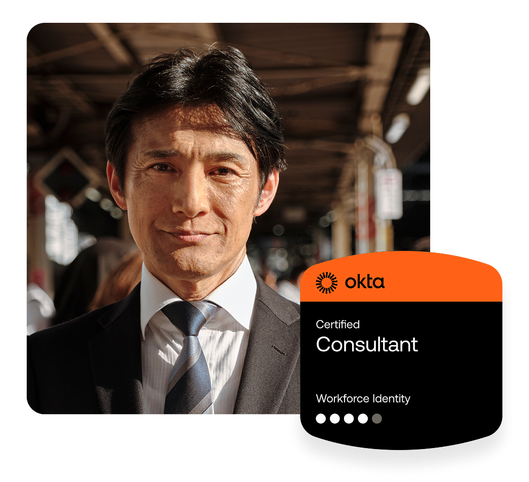 Man in a suit and tie smiling at the camera, next to an Okta Certified Consultant badge.